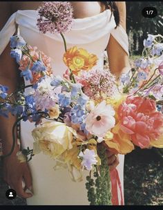 a woman holding a bouquet of flowers in her hands