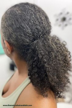 black woman with a curly ponytail