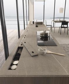 a kitchen counter top with some bowls and cups on it