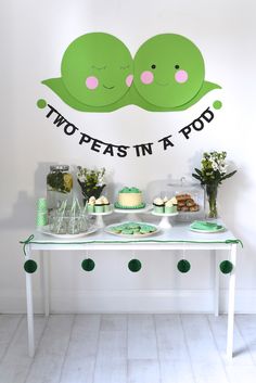 two peas in a pod birthday party with cake and cupcakes on the table