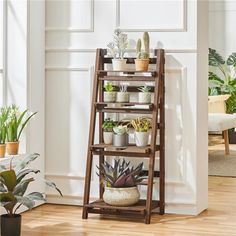 a wooden plant stand with potted plants on it