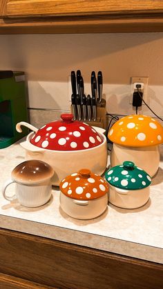 the kitchen counter is covered with different types of cooking utensils and pots on it