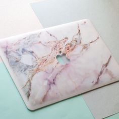 a marbled macbook pro case with an apple logo on it