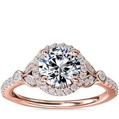 a white gold engagement ring with an intricate halo setting