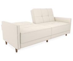 a white leather couch sitting on top of a hard wood floor