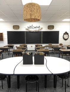 an empty classroom with desks and chairs in front of a welcome sign on the wall