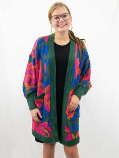 floral multicolor cardigan on model Bohemian Green Cardigan For Fall, Colorful Cozy Outerwear For Spring, Green Bohemian Cardigan For Fall, Casual Multicolor Sweater With Pockets, Casual Green One Size Outerwear, Trendy Green Sweater With Pockets, Colorful One Size Cardigan For Fall, One Size Green Outerwear For Fall, One Size Floral Print Cardigan For Fall