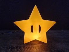 a yellow star shaped light sitting on top of a wooden table