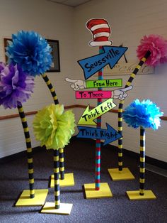 the cat in the hat themed classroom decor is displayed with paper pom poms