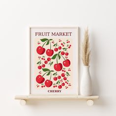 a fruit market poster on a shelf next to a vase with a plant in it