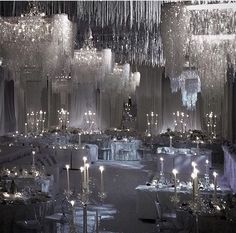 an elegant ballroom with chandeliers and tables