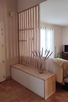 a living room with a couch, table and window