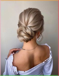 a woman with blonde hair in a low bun