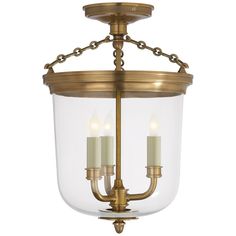 an antique brass chandelier with two candles in the center and clear glass shades