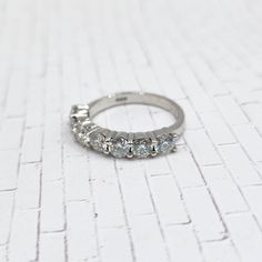 "Stones: Moissanite Stones Cut: Faceted Rounds Stones Dimensions: 4mm Carat Weight: 2DEW (diamond equivalent weight) - Setting: Platinum over Sterling Silver, Stamped \"925\" Size: 8 Condition: Excellent, Very Minor Signs of Wear - This is the EXACT ring that you'll be receiving, so please look at the pictures closely to ensure that you'll love it! Your ring will be carefully packaged in a jewelry box. Your item will ship from Wisconsin within 1-3 days of purchase." Cottage Grove, Weight Set, Moissanite Ring, Stone Cuts, Moissanite Rings, Stackable Rings, Jewelry Box, Platinum, Jewelry Rings