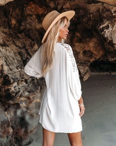 Relaxed Fit SelfC 100% Rayon and ContrastC 80% Cotton and 20% Nylon Dry Clean Only Split Neckline with Neck Tie Closure Half Sleeves with Elastic Cuff Crepey Fabrication Lace Trimming Not LinedC Sheer Our Calabasas Lace Up Cover-Up Dress is the only beach cover-up you'll need all year! This white relaxed mini dress has a split neckline and a necktie. Designed with a delicate lace detailing along the shoulders. Styled with the Aussie Straw Hat. Perfect Hoop Earrings. Diamond Charm Choker. The Bud Ruffle Midi Dress, Party Dress Long Sleeve, Puff Sleeve Dresses, Cotton Midi Dress, By Your Side, Party Dress Long, Boho Maxi Dress, Cover Up Dress, Two Piece Dress