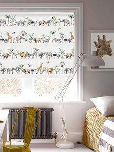 an animal themed window covering in a child's room with a chair and desk