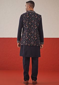 Elevate your ethnic style with the Navy Blue Jacket Kurta set. Crafted from luxurious georgette, the jacket features resham and sequinned embroidery. The Yoke design kurta with embroidered cuffs and is paired with matching pants, ensures elegance and comfort. Perfect for special occasions like Sangeet, Mehendi, or as a wedding guest outfit. Composition : Jacket, Kurta & Trouser : Viscose Georgette Care: Dry Clean Only and Vacuum Storage This product can be customized for sleeves, length and colo Kurta Set With Jacket, Embroidered Cuffs, Design Kurta, Yoke Design, Vacuum Storage, Navy Blue Jacket, Indian Wedding Wear, Matching Pants, Kurta Designs