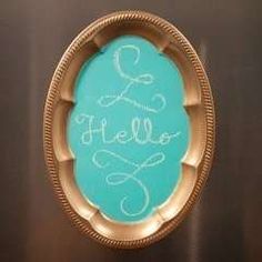 there is a blue plate with the word hello written in white on it and gold trimmings