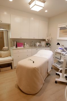 a room with a bed, chair and other medical equipment