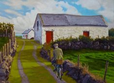 a painting of a man riding a bike down a country road next to a barn