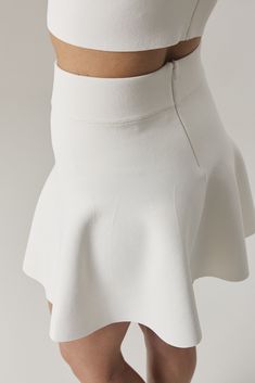 Perfectly youthful, the Chelsie mini skirt is fitted through the high hip and flares in a flattering full silhouette. The dense stretch knit comfortably hugs the body from waist to hip. Circular knitted, with no side seams, the skirt closes with a concealed zipper at center back. Youthful and fun, wear yours as part of a set with our matching bralette. Shown here in Sugar. Size and Fit: - Fits true to size. Take your regular size. - Meant to sit at waist. Can also be pulled down and worn on the Birkenstock Eva Arizona, Cream Converse, Knit Mini Skirt, High Hips, Sweater Shop, Mini Skirt, Care Instructions, Inside Out, Womens Skirt