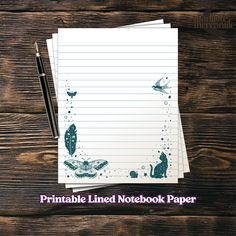 notebook with lined paper and butterflies on it, next to a pen that says printable lined notebook paper