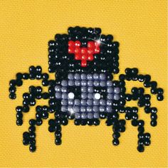 an image of a beaded spider on a yellow background