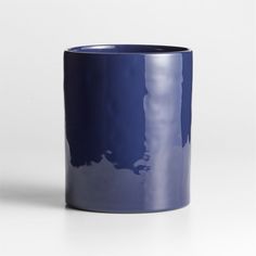 a blue cup sitting on top of a white table