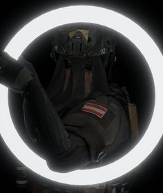 a person with a helmet on sitting in front of a circular light