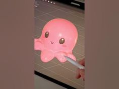 someone is using a toothbrush to clean an octopus