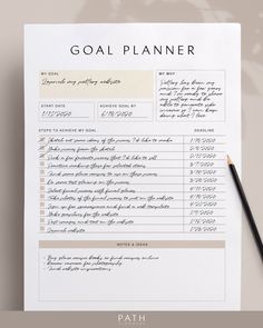 the goal planner is sitting on top of a piece of paper