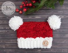 a red and white knitted hat with pom poms