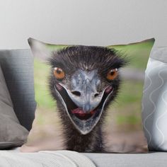 an ostrich's face with orange eyes throw pillow