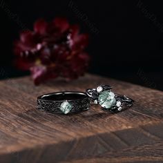 two wedding rings sitting on top of a wooden table