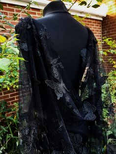 Get ready to channel your inner gothic queen with this stunning Black Gothic Cape. Perfect for a wedding or any special occasion, this cape features exquisite details like delicate butterflies, adding a touch of whimsy to your ensemble. Designed as a wrap for both the bride or bridesmaid, this cape is made with high-quality materials, ensuring both comfort and durability. With its elegant and mysterious vibe, this Black Gothic Cape will make you feel like the ultimate enchantress on your big day. Colour: black. Please,message me if you need custom colour. Size: 300CM*150CM -------------------- International Shoppers: Please send me a message with your location for details about shipping costs as there are faster deliveries available. Add our shop to your Favorites to get the unique coupon Gothic Cape, Bridal Cape Veil, Black Wedding Veil, Witchy Wedding, Fabric Closet, Cathedral Design, Gothic Queen, Cape Veil, Wedding Shawls