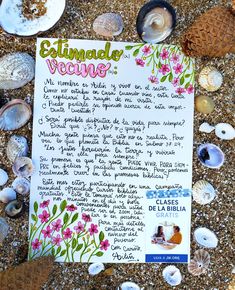 a close up of a paper with writing on it surrounded by shells and seashells