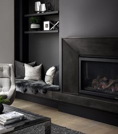 a living room filled with furniture and a fire place in front of a book shelf