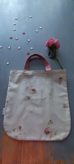 The Floral vintage print tote bag -   I have used vintage remnants of a pale cream fabric adorned with beautiful delicate pink roses. The pink cotton twill handles compliment the rose colour.  Inside there is a contrast pocket made from a retro print cotton combined with a remnant of floral in green to match the rose print. There is french seam detail on the inside of the bag and the added design detail of curved corners!  The bag is approx 42cms wide and 43cms length, so plenty big enough for the Sunday papers and some light shopping! Pink Floral Print Cotton Bag, Cream Rectangular Bag With Floral Print, Rectangular Cream Bag With Floral Print, Cream Floral Print Rectangular Bag, Cream Fabric, Vintage Floral Print, French Seam, Retro Print, Floral Vintage