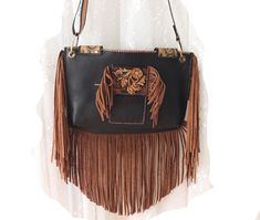 Reflecting western style, this western bag is the perfect accessory for those who love cowboy and rodeo themes. An elegant and stylish crossbody bag made of high quality leather material. Ideal for daily use, this bag is both practical and fashionable.  Ideal for festivals and outdoor events, this bag is made of durable black and brown leather. It offers comfortable use with its lightweight and useful design. It was also designed for those who embrace both Native American culture and Bohemian st Western Style Bags For Festivals, Western Style Saddle Bags For Everyday Use, Bohemian Saddle Shoulder Bag For Everyday Use, Bohemian Saddle Bag For Everyday Use, Western Style Brown Bags For Rodeo, Western Saddle Bag For Everyday Use, Rectangular Brown Bag For Rodeo, Western Style Crossbody Shoulder Bag For Travel, Western Style Rectangular Bags For Western-themed Events