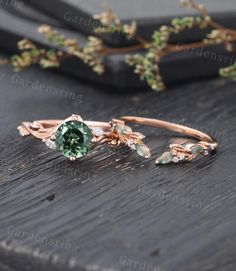 a close up of a ring on top of a wooden table with flowers and leaves