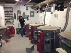 a woman standing in front of some machines