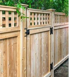 a wooden fence is shown with black hardware on the top and bottom bars that are attached to it