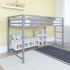 a bunk bed sitting next to a white book shelf