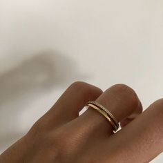 a woman's hand with a diamond ring on it