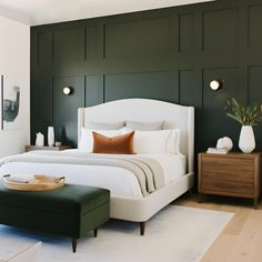 a bedroom with green paneled walls and a white bed in the middle, along with a footstool