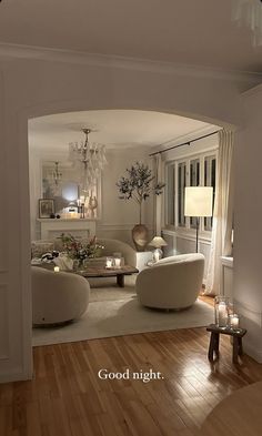 a living room filled with furniture and a chandelier