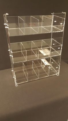 clear acrylic display case with drawers on the bottom and sides for storing items