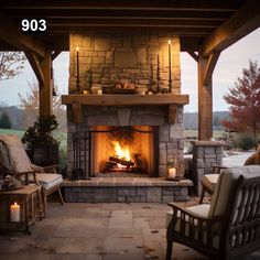 an outdoor fireplace with chairs around it and candles on the fire place in front of it