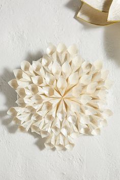 a large white flower sitting on top of a table